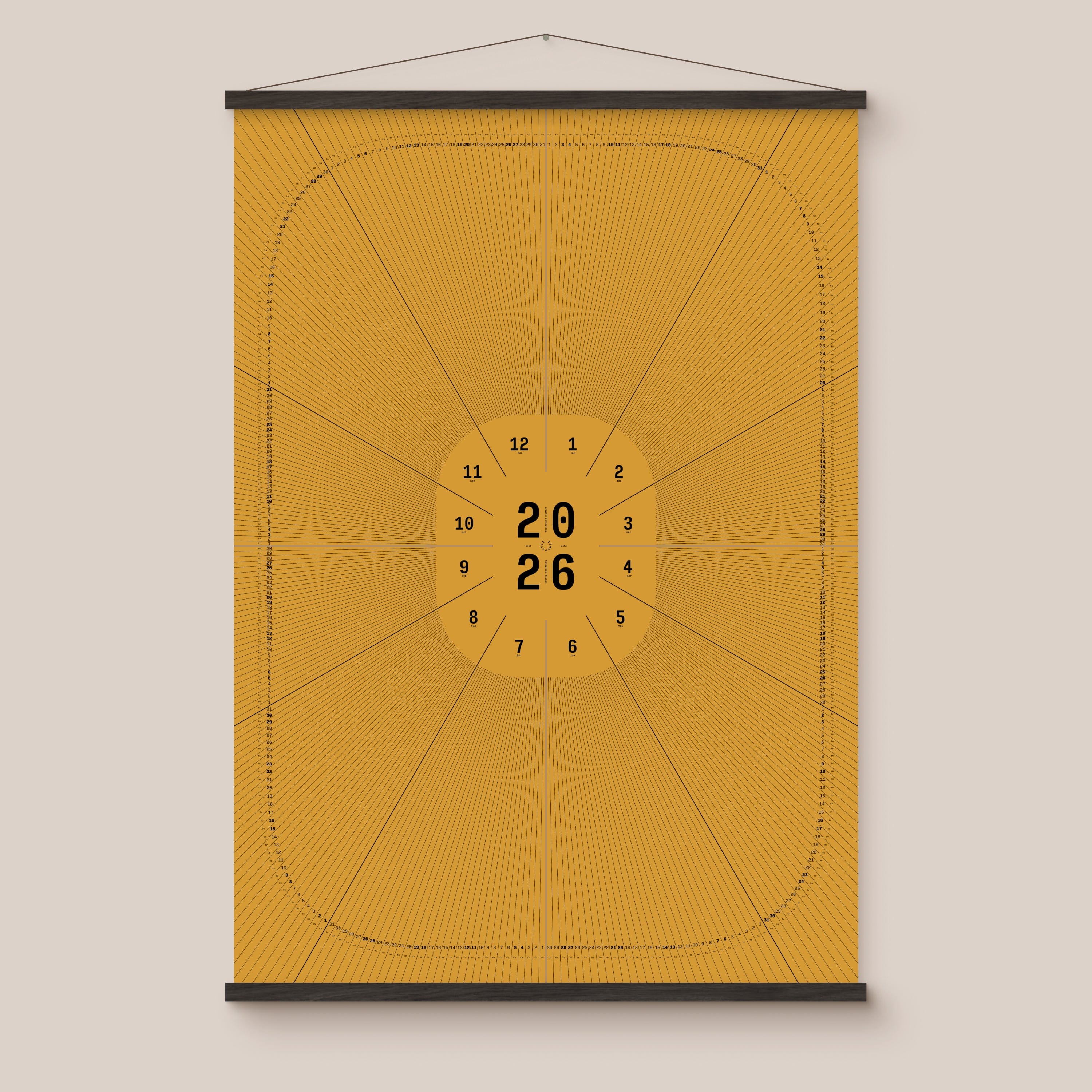 Yellow geometric calendar with a circular design and numbers on a beige wall, black wooden hanger frame