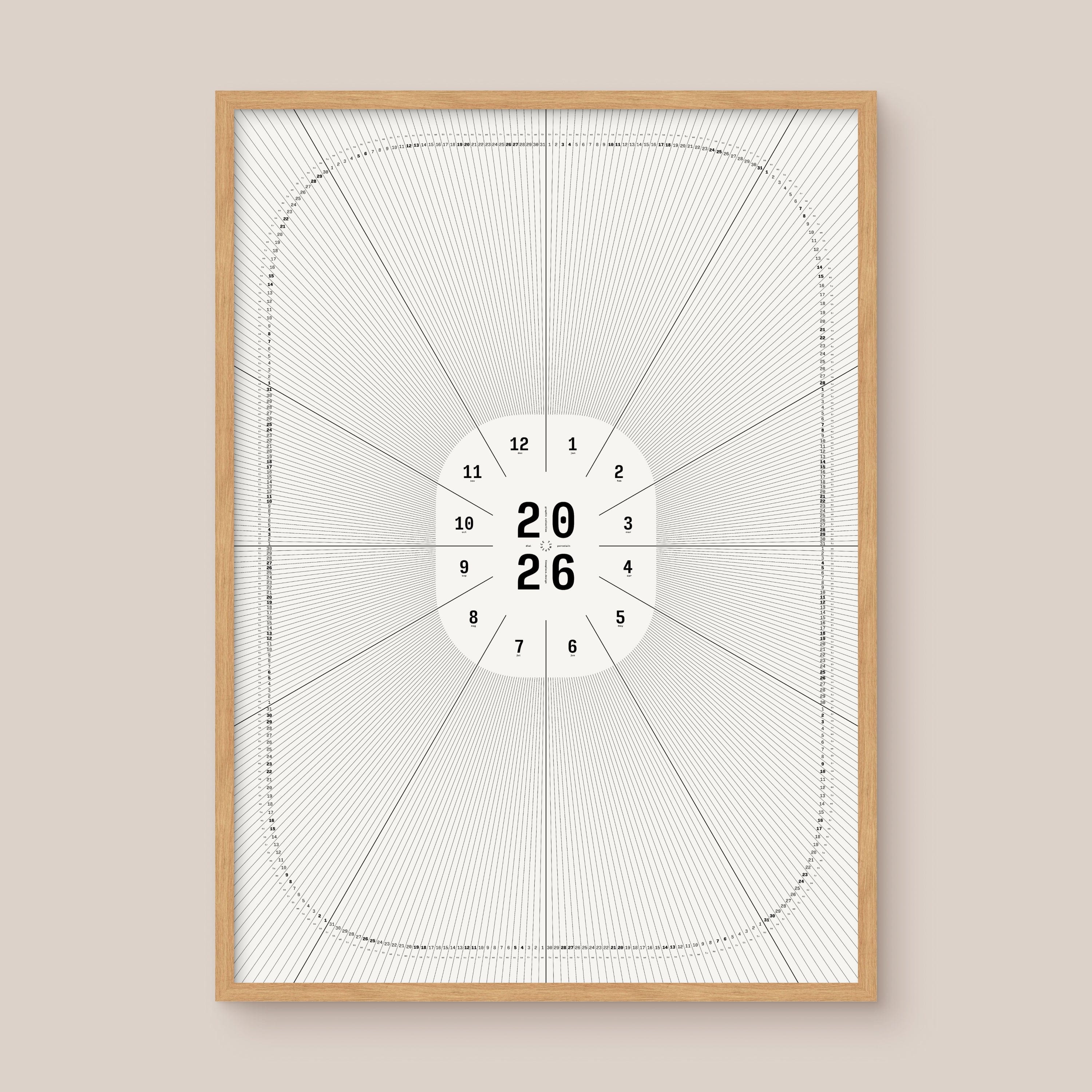Framed geometric calendar with a circular design and numbers on a beige wall, natural wood frame