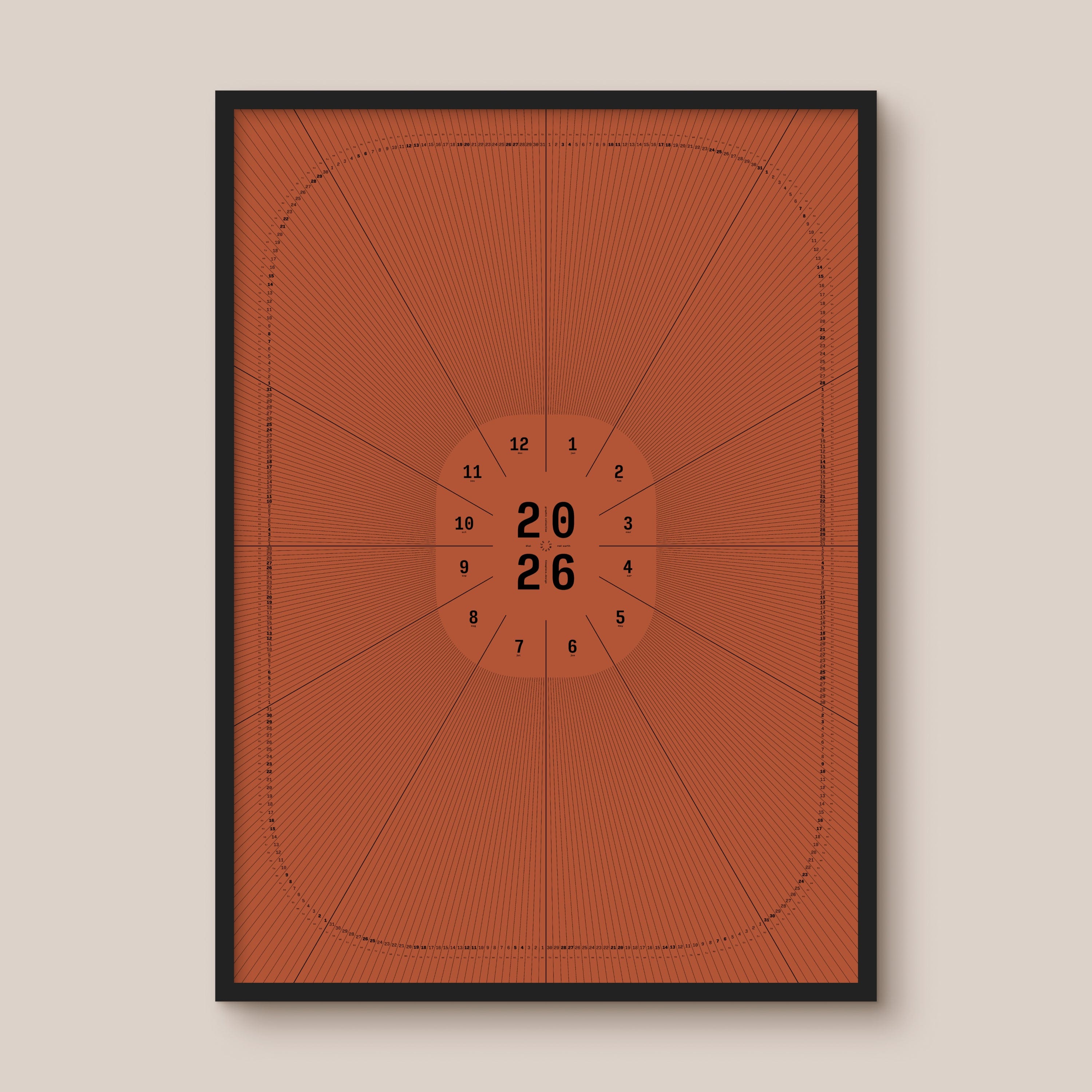 Red geometric calendar with a circular design and numbers on a beige wall, black wooden frame