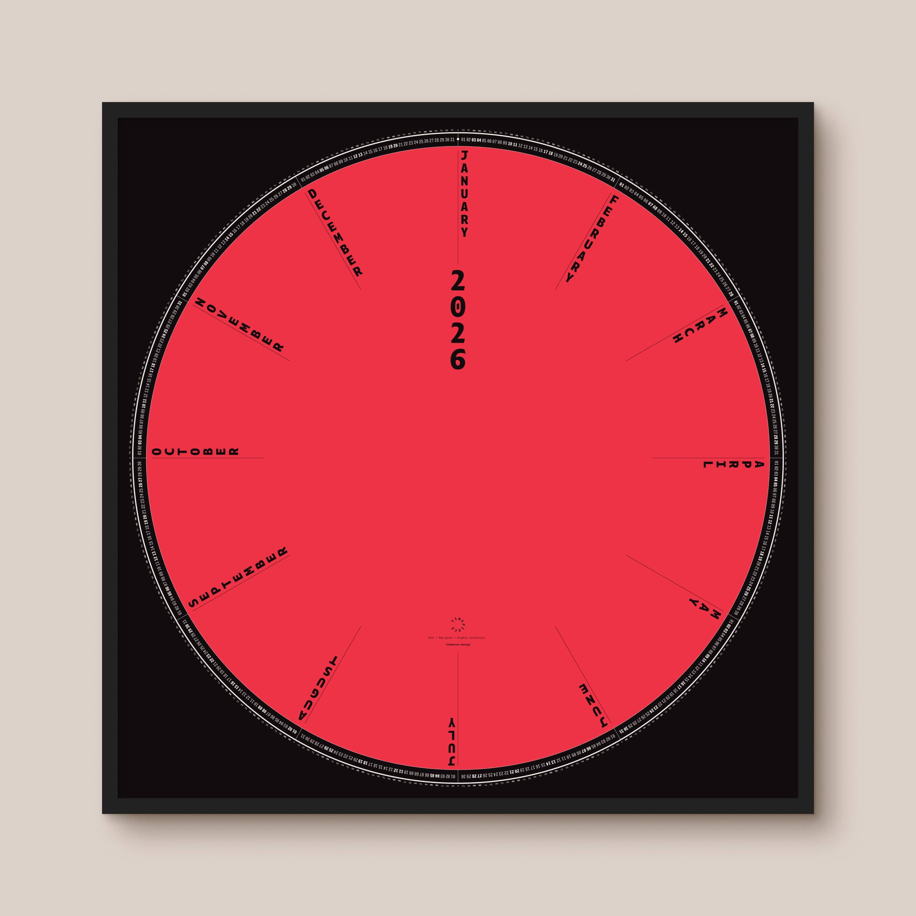 Circular red and black calendar with '2026' and text on a beige background, black wooden frame