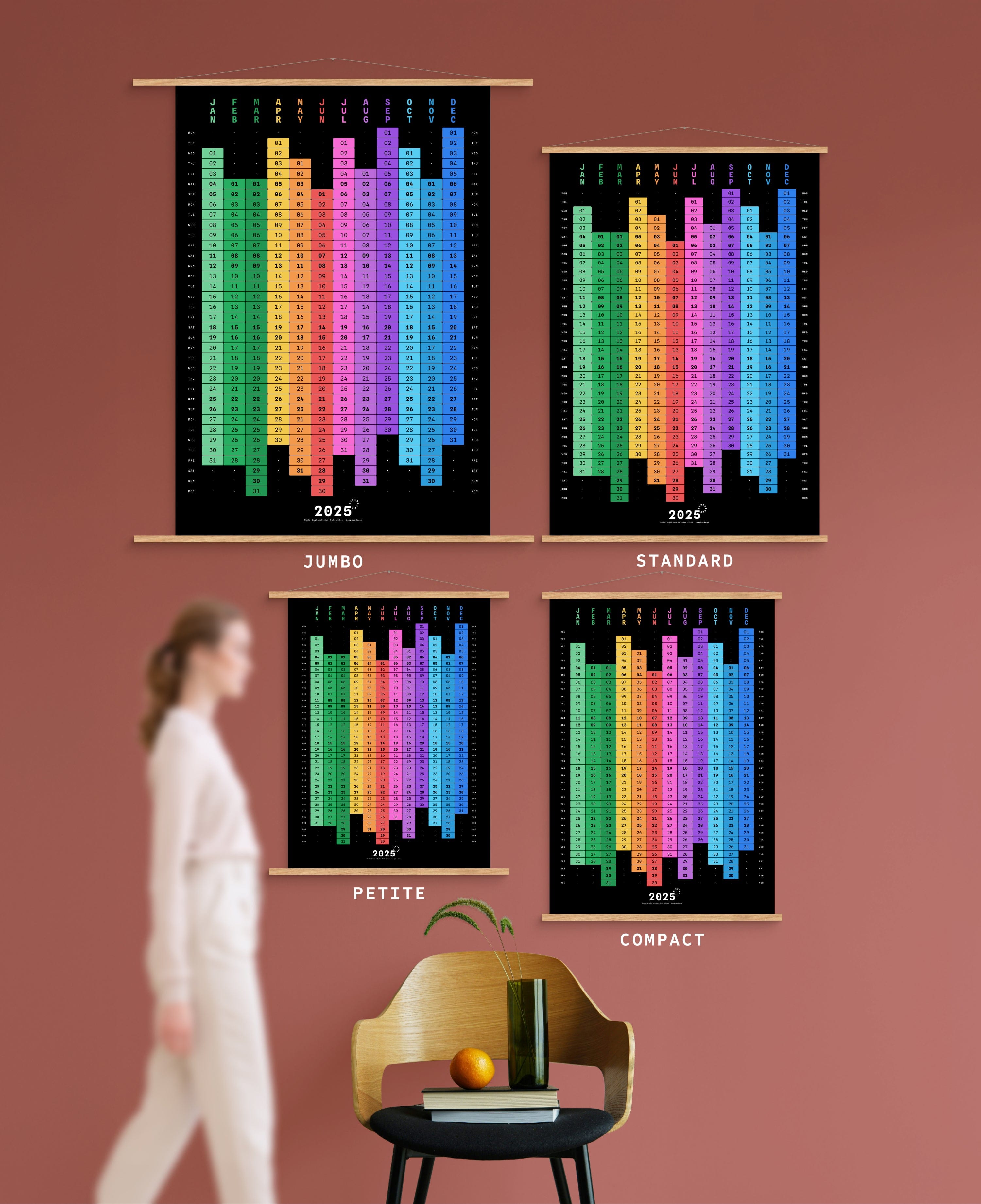 4 sizes of Blocks yearly calendar on green wall, with person, chair, orange and vase shown for scale